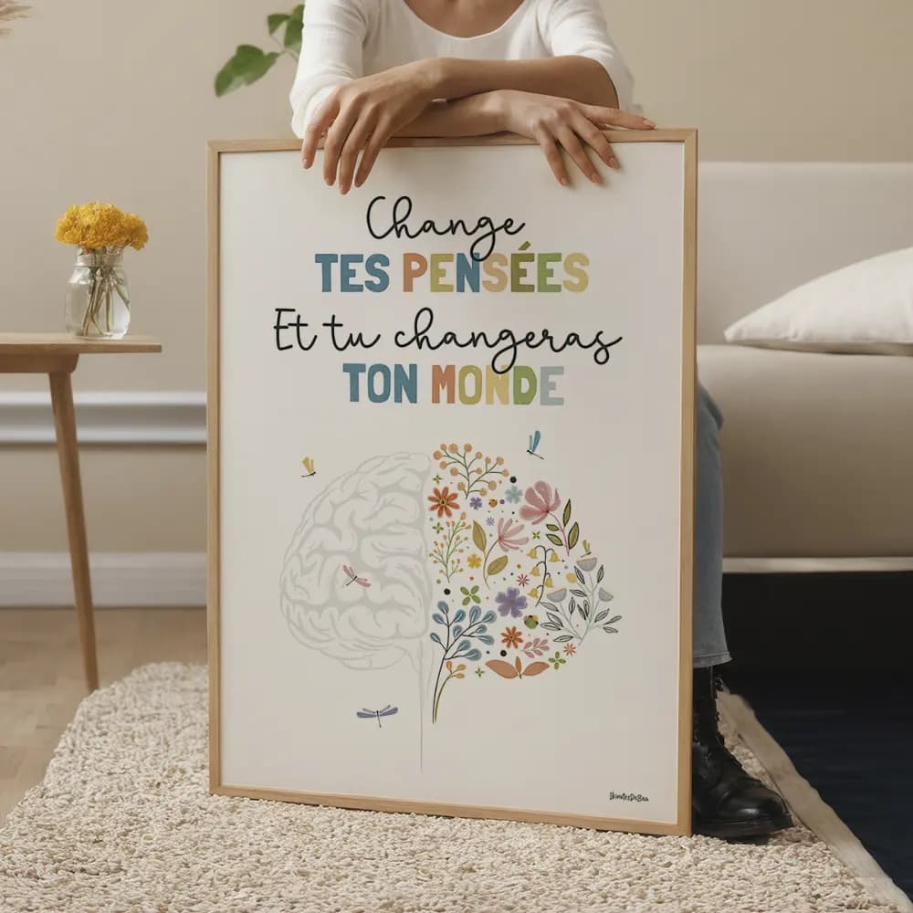 Belle illustration de cerveau floral, ornée de fleurs éclatantes et délicates, avec des libellules gracieuses posées dessus et autour. Le message "Change tes pensées et tu changeras ton monde" inspire à voir la beauté et le potentiel de transformation en chacun de nous.